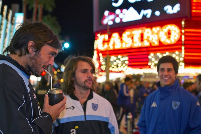 Players from Uruguay drink mate as they arrive at Casino Center preceding a parade for the USA Sevens International Rugby Tournament  players held at the Fremont Street Experience on Thursday, Jan. 23, 2014.